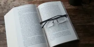 Glasses sitting on an open book.